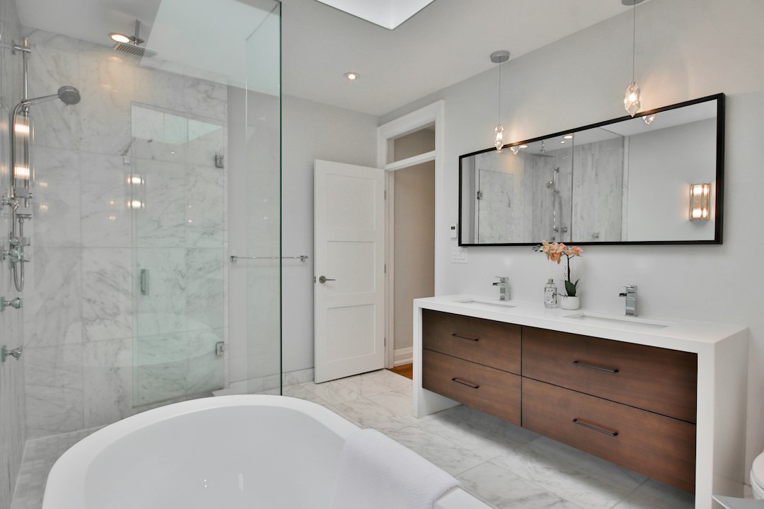 a-bathroom-with-a-large-white-bathtub-next-to-a-walk-in-shower-dk-o7kqygki